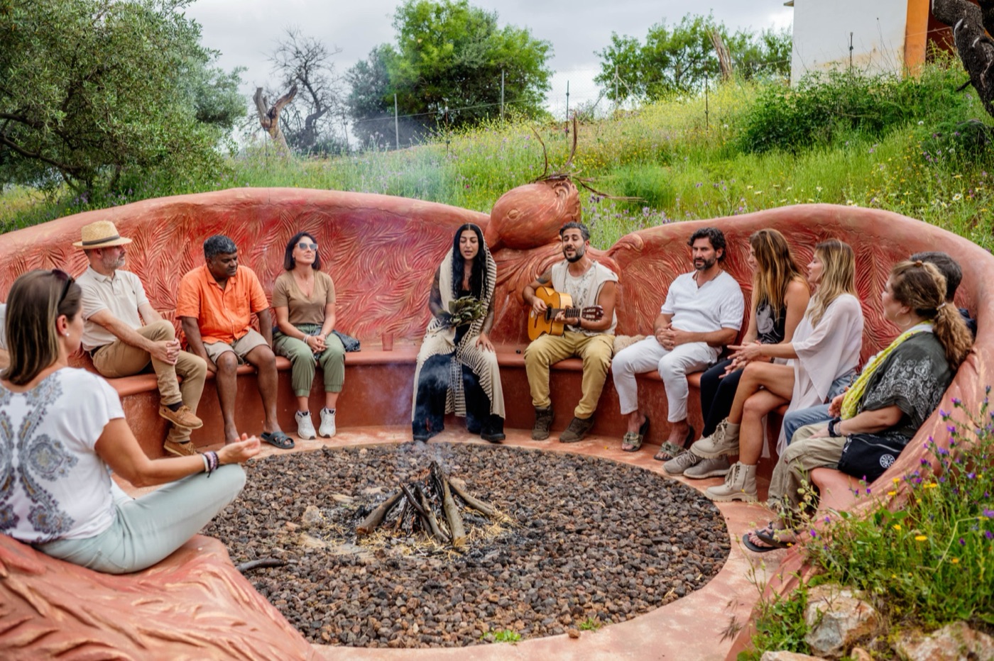 A guest circle gathered in the outdoor sanctuary