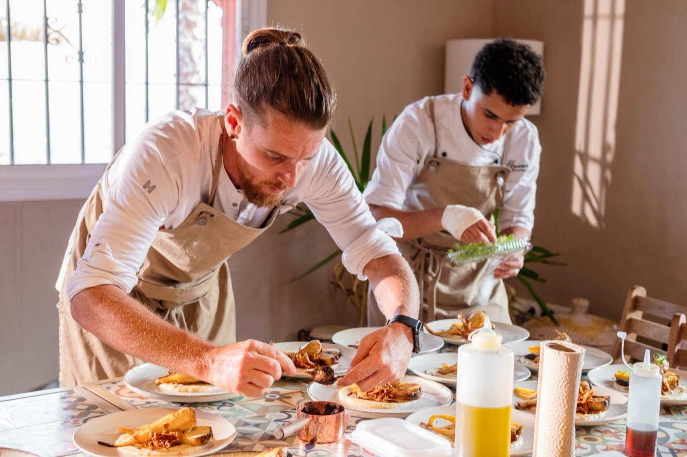 Two chefs working side by side in the kitchen