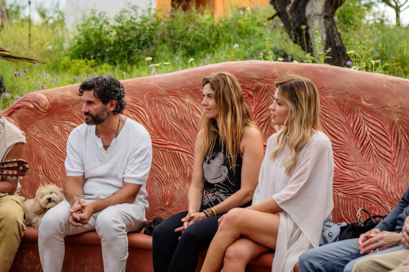 Friends sitting close together on the curved bench